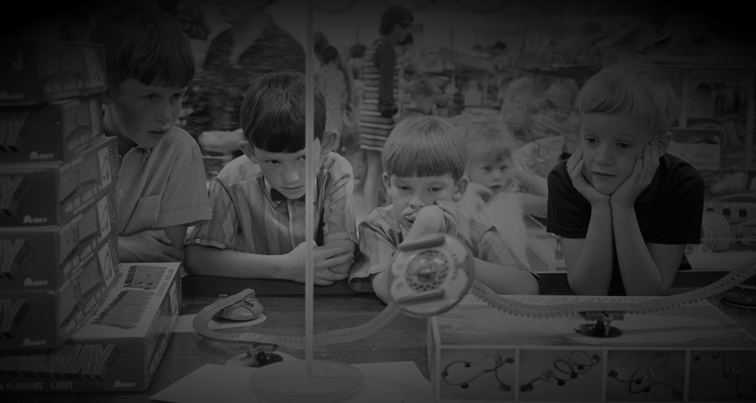 Group of children looking at a space-themed toy in a shop