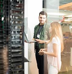 Professionals in front of a server rack. 