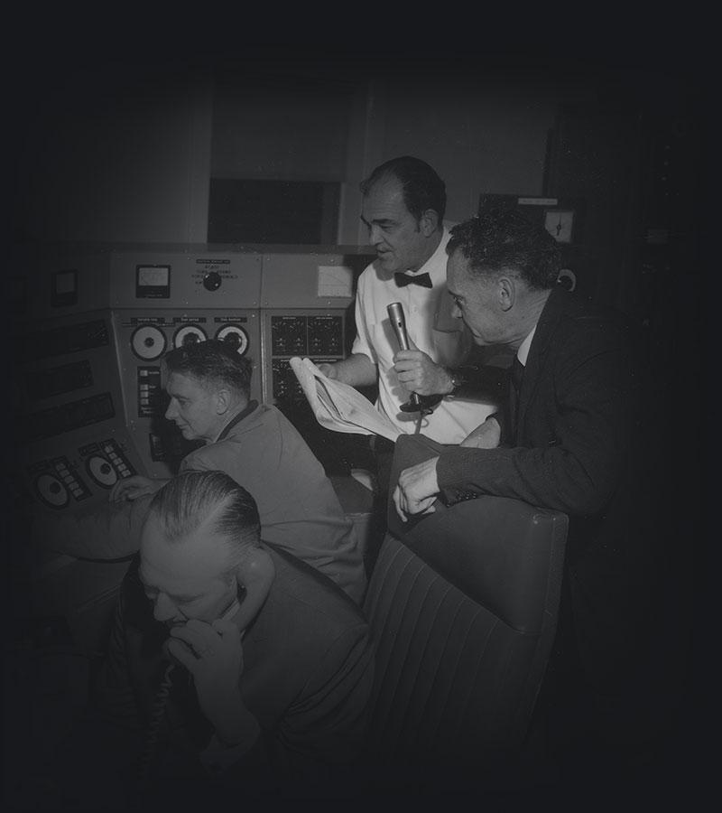 Four men, Australian and American scientists in the control room of Australia's radio telescope at Parkes. 