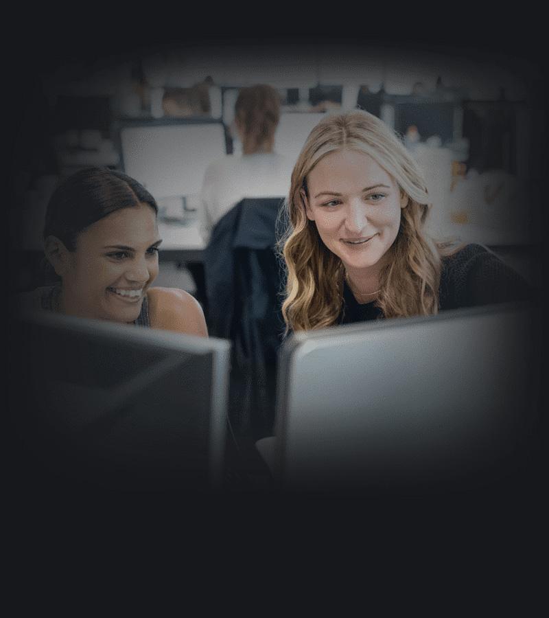 Two women working in office.