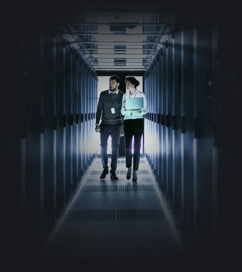 Colleagues discussing in office server room.