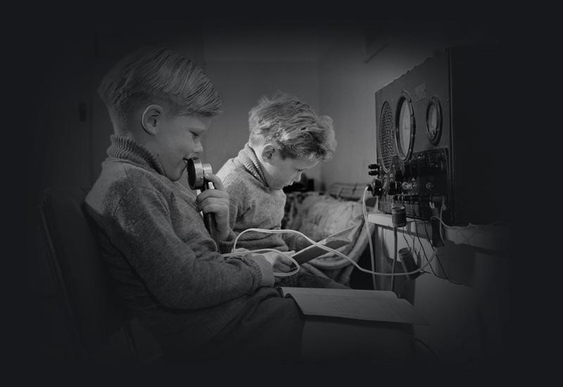 Two young boys using transceiver radio.