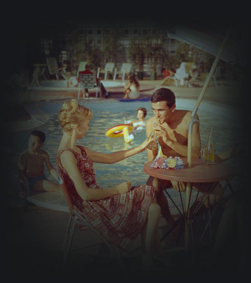Family dining next to a motel pool. 
