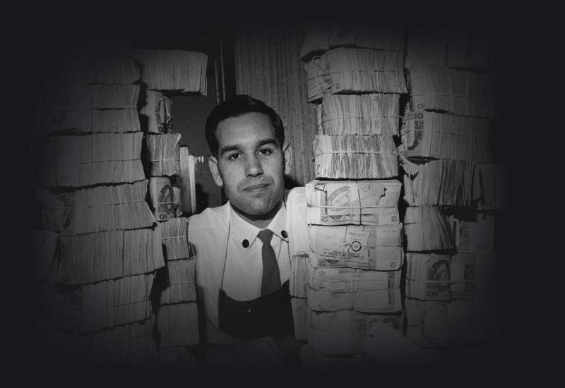  Robert Webb among the dollar notes in the vault of the Reserve Bank of Australia where he works, 1967.