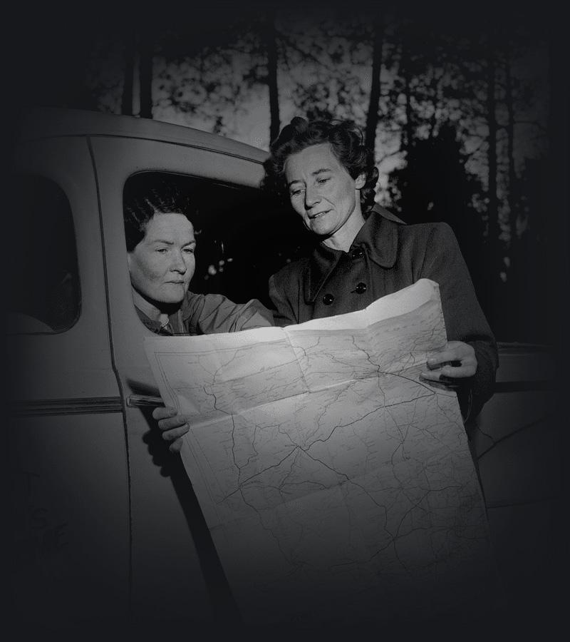 Sisters Graves and Fawcett of the New South Wales Far West Children's Health Scheme study a map. 