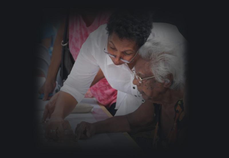 Phyllis Williams showing her mother the Larrakia petition. 
