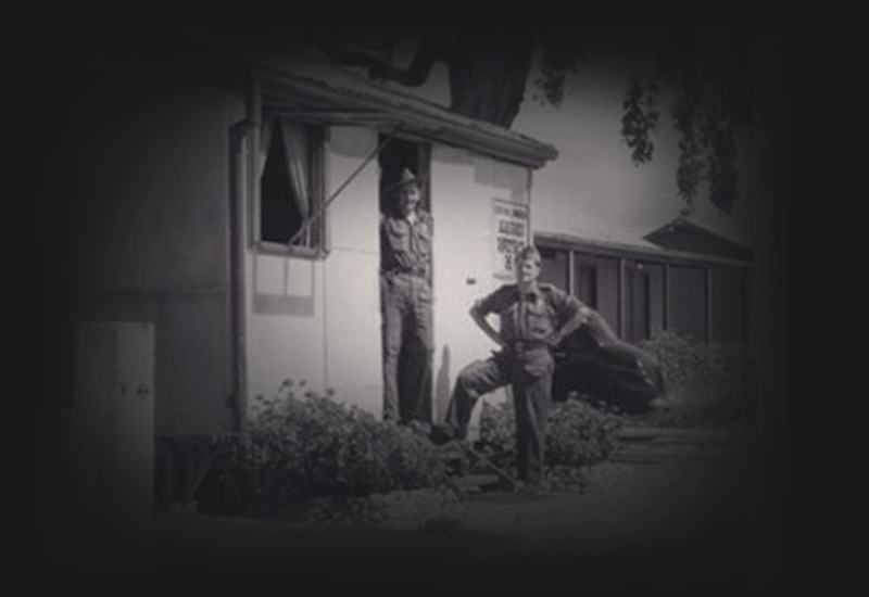 Laszlo Makay and another man in uniform as camp patrolmen at Bonegilla Migrant Centre. 