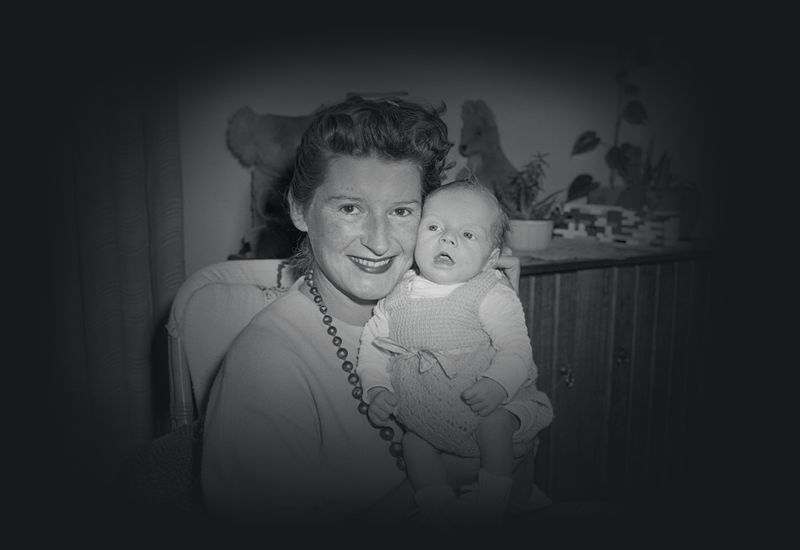 Adriana smiling and holding her baby Ricky.