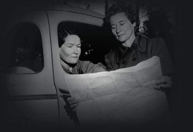 Sisters Graves and Fawcett of the New South Wales Far West Children's Health Scheme study a map. 