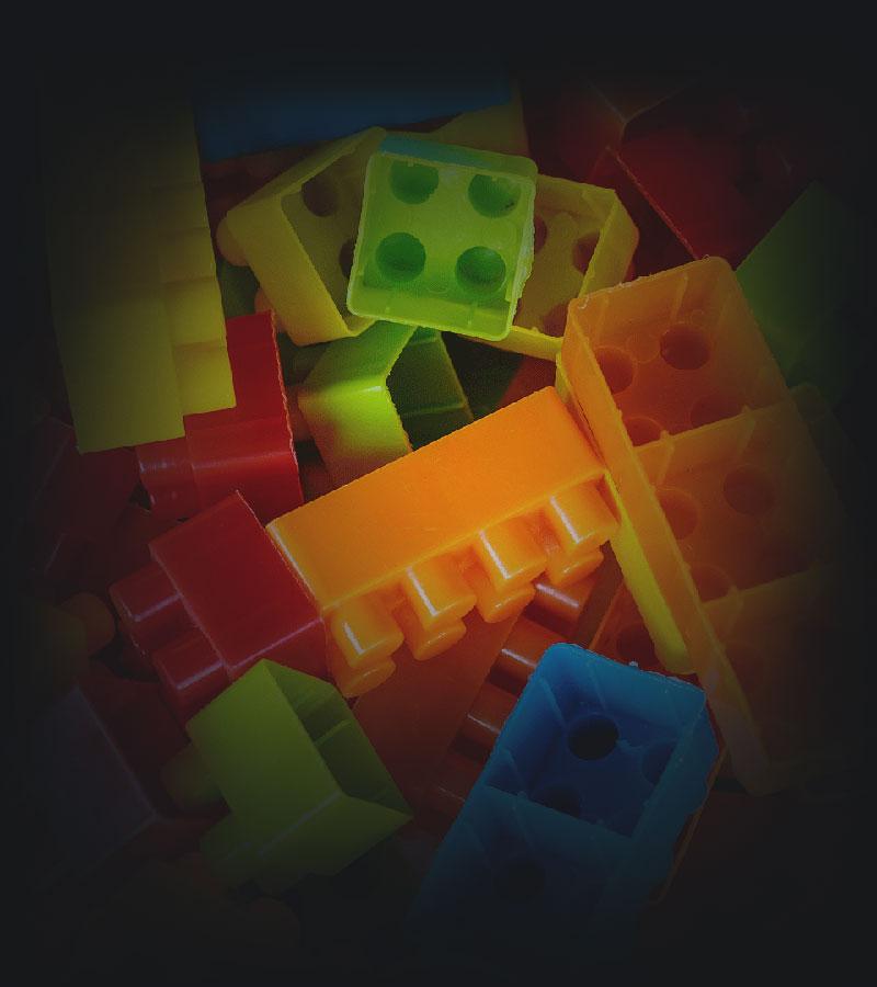 Brightly coloured plastic toy connectng blocks.