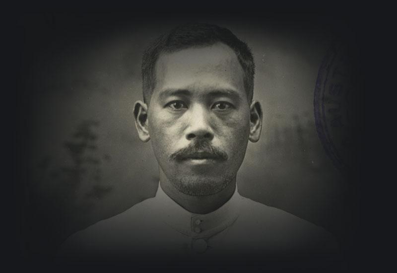 An immigration portrait of a man with a moustache