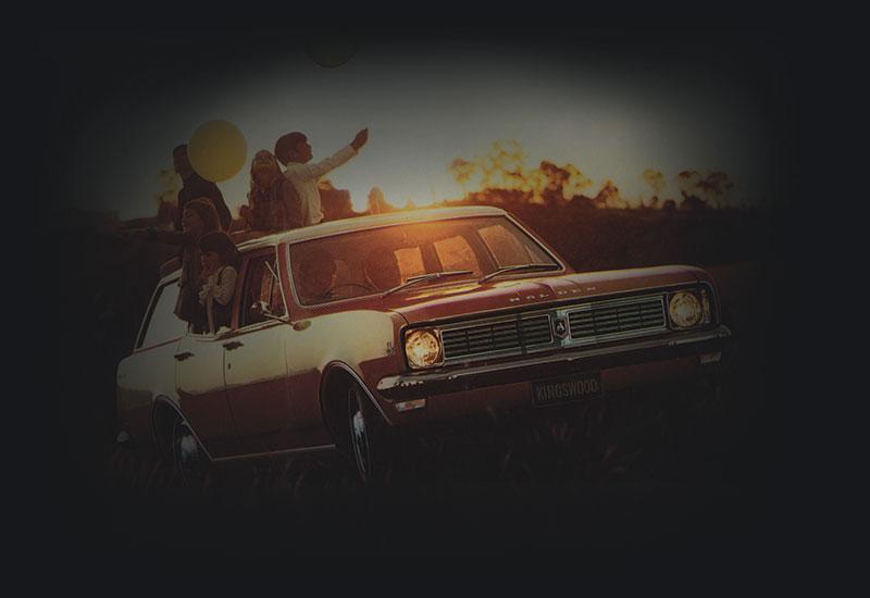A family in an HT Holden Kingswood Station Wagon.