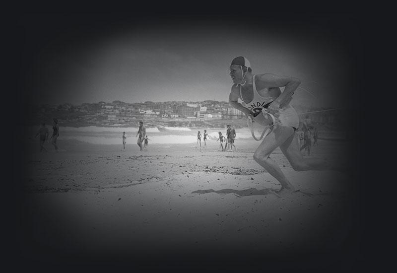 A bondi Beach surf lifesaver running toward the water.
