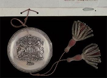 Photograph - Detail of Royal Assent document skippet, containing wax seal.