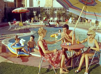 Guests dining by the motel pool.