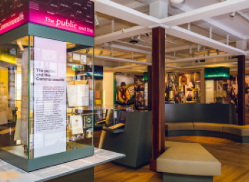 Display case and immigration photo mural, Connections Gallery, National Archives of Australia
