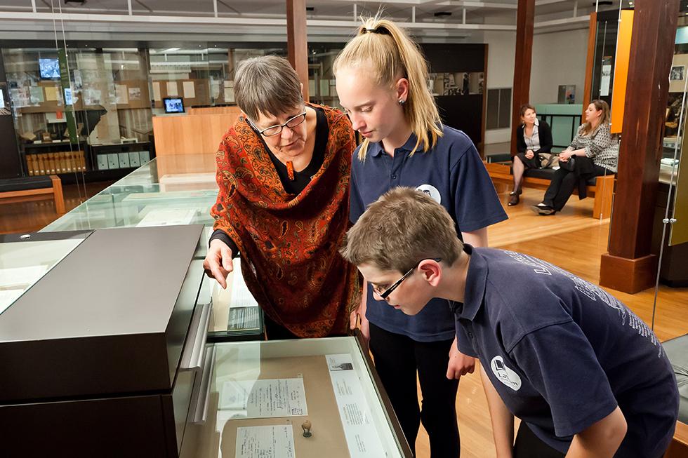 Students viewing a lottery ball used for conscription during the Vietnam War