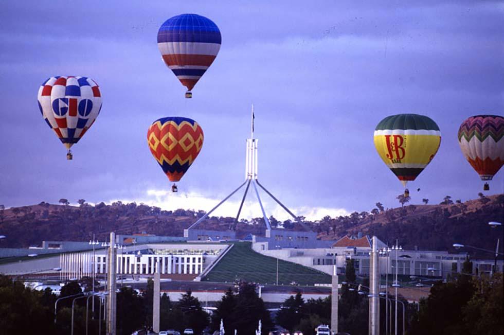 Hot air balloons flying over Parliament House during the Canberra