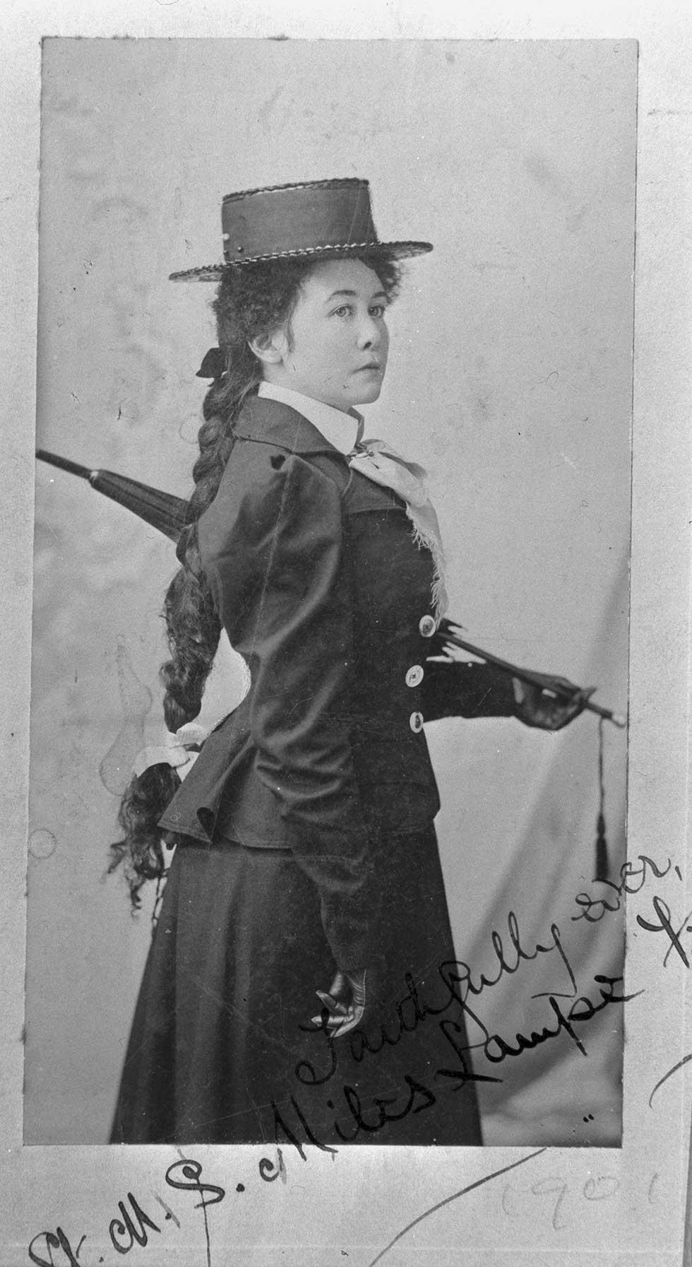 Portrait of Miles Franklin wearing a hat and holding a parasol.