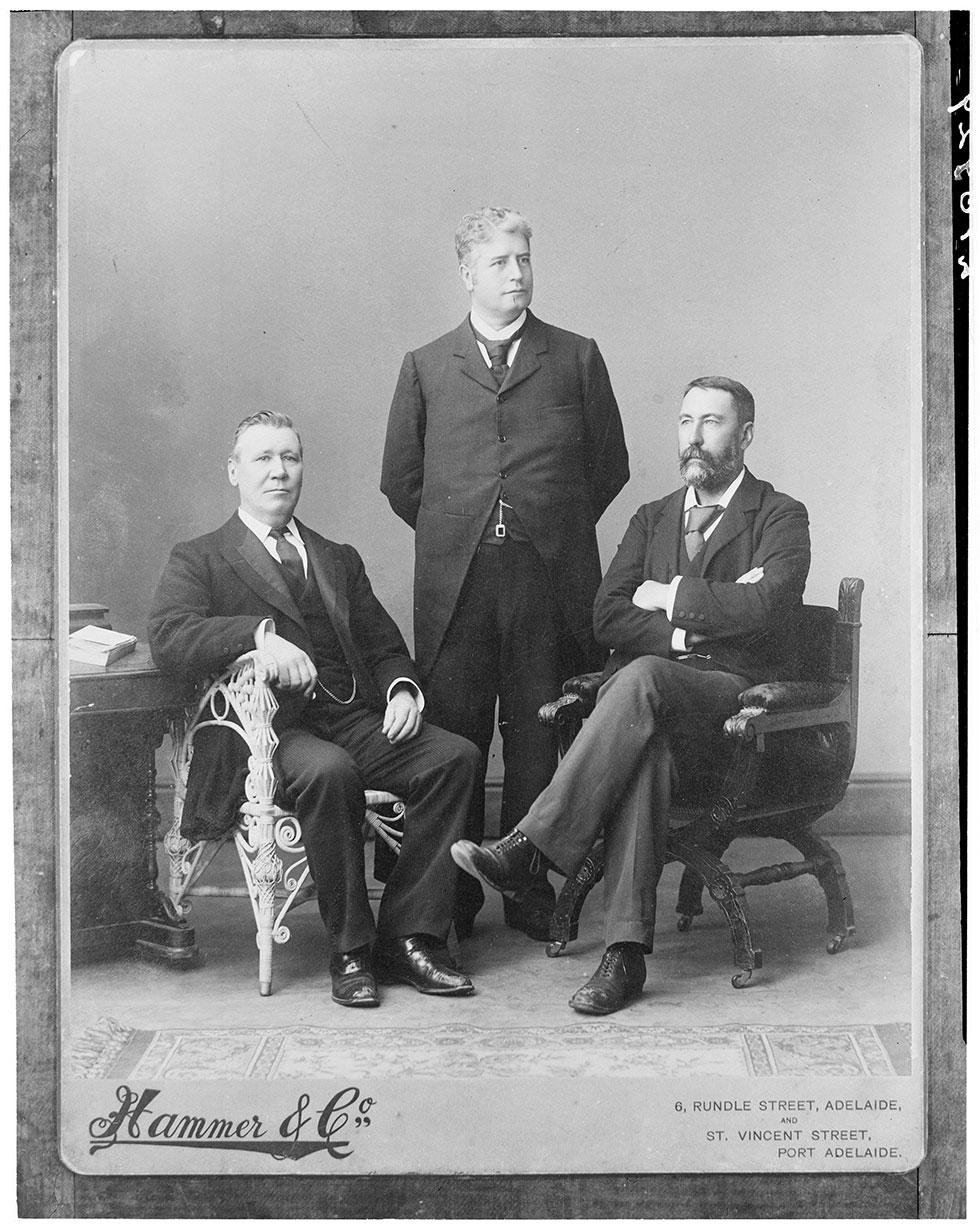 At the Federal Convention, Adelaide, March 1897 The drafting of the Australian Constitution was enstrusted to three lawyers, shown here: Mr (later Sir) Edmund Barton (standing), Sir John Downer (left) and Mr Richard O'Connor (right) who became a Justice of the High Court of Australia on its establishment in 1903.
