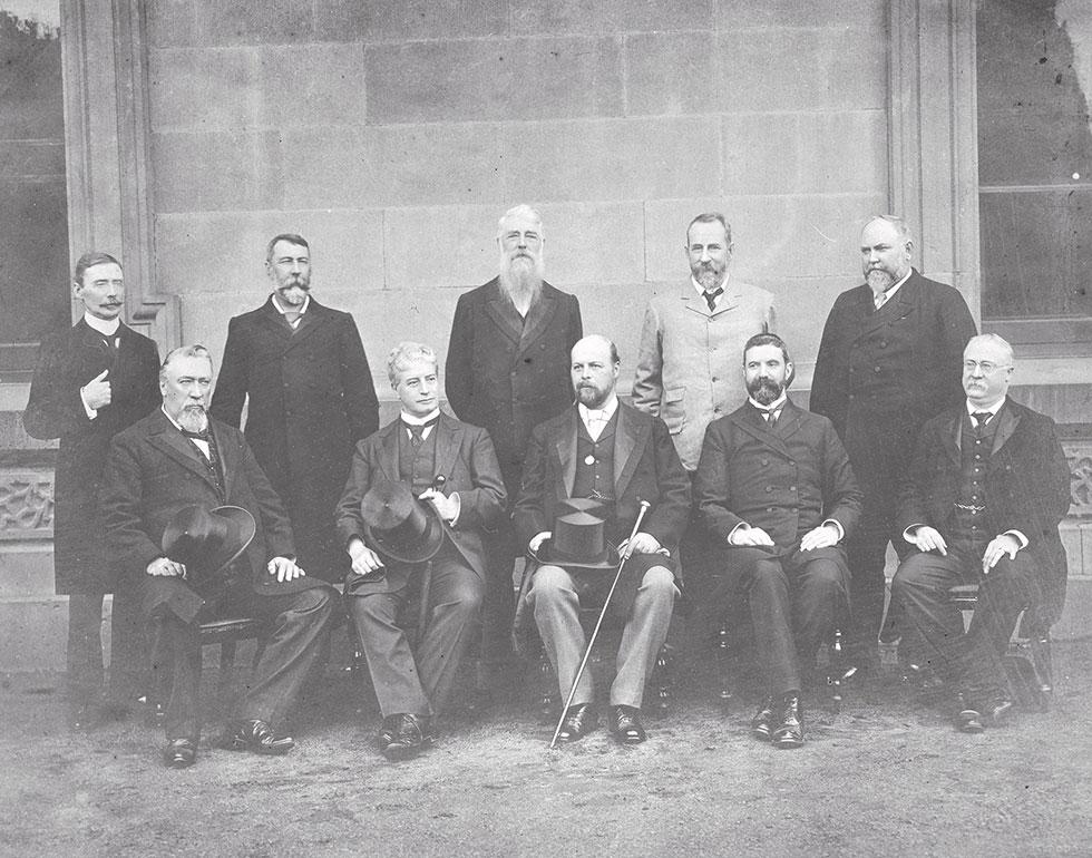 The Ministry of the Barton Government taken in 1902/1903. From Left to Right (standing): Senator James George Drake, Senator Richard Edward O'Connor, the Hon Sir Philip Oakley Fysh, the Hon Charles Cameron Kingston, the Hon Sir John Forrest. Seated: the Hon Sir William John Lyne, the Rt Hon Edmund Barton, Governor-General Lord Tennyson, the Hon Alfred Deakin, the Hon Sir George Turner.