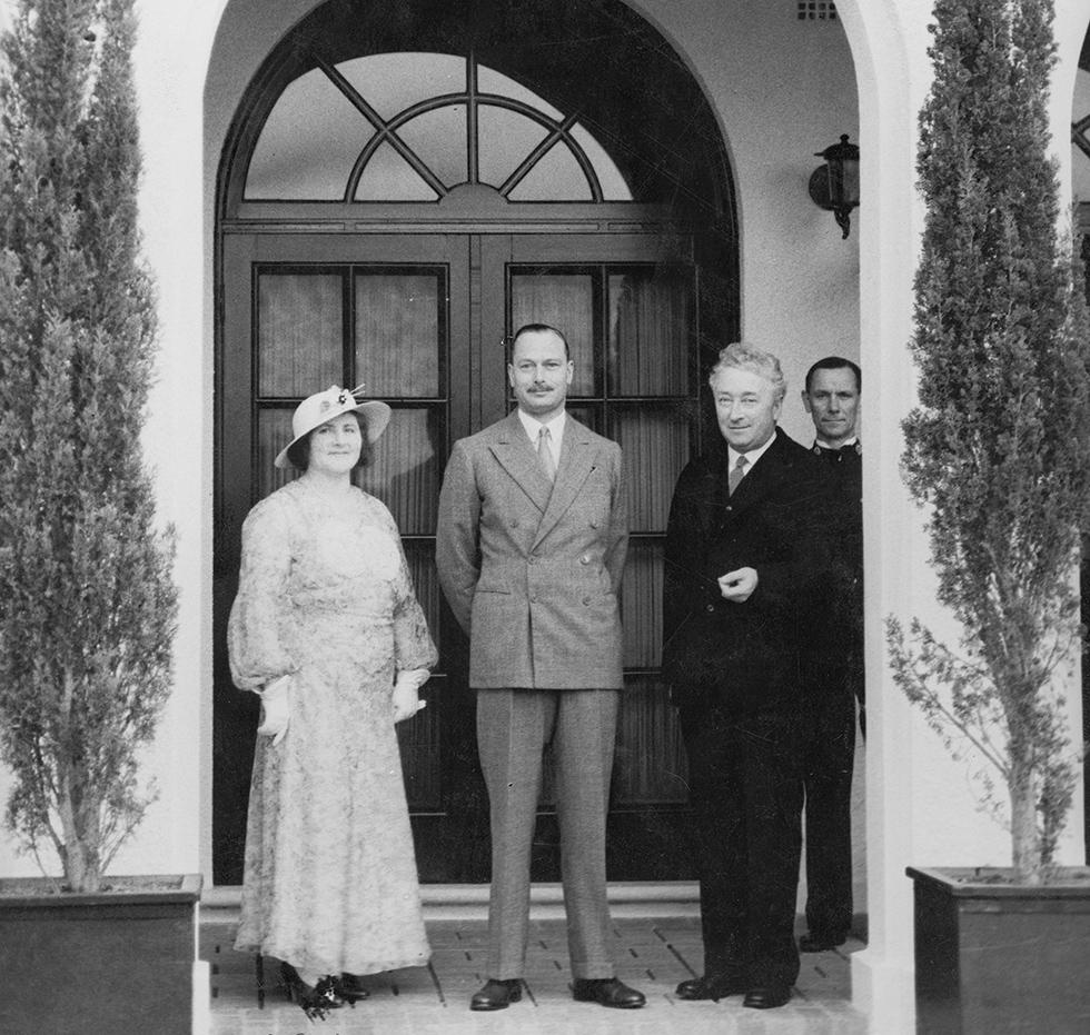 Dame Enid Lyons at The Lodge on 24 October 1934, with the Prime Minister and Prince Henry, the Duke of Gloucester during the royal tour for the Victorian centenary celebrations.