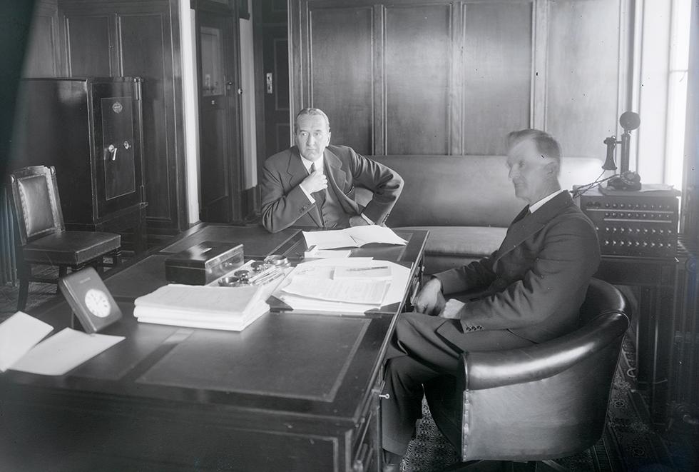 Outgoing Prime Minister SM Bruce handing over to James Scullin in the Prime Minister’s office in Parliament House, on 23 October 1929.