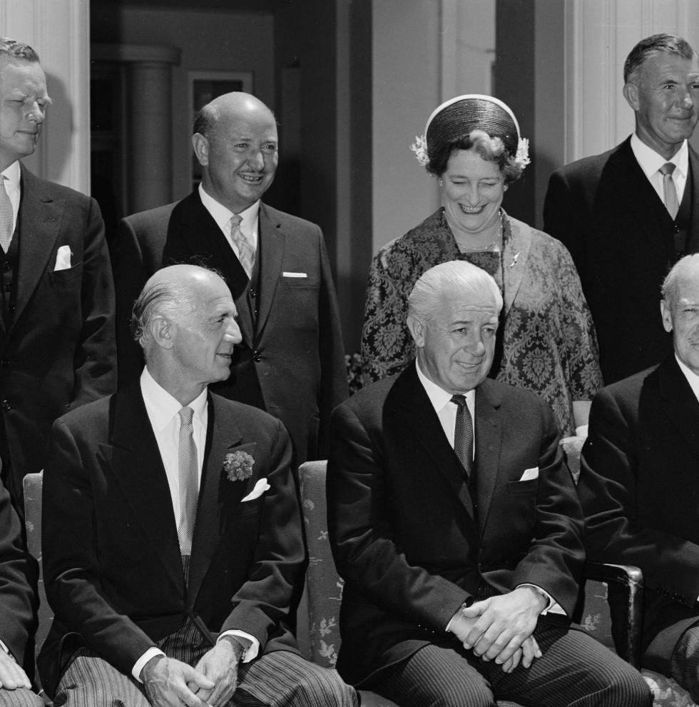Treasurer William McMahon (seated, left) at the swearing-in of the Holt ministry at Government House on 26 January 1966, Prime Minister Harold Holt and the Governor-General Lord Casey. Standing are Minister for Civil Aviation Reg Swartz (left), Minister for Housing Annabelle Rankin, and Gordon Freeth, Minister for Shipping and Transport.