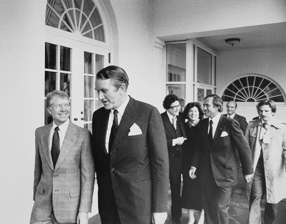 US President Jimmy Carter with Prime Minister Malcolm Fraser walking along a veranda at the White House. 