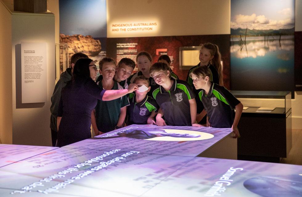 Students viewing a piece of vellum in the Voices exhibition.