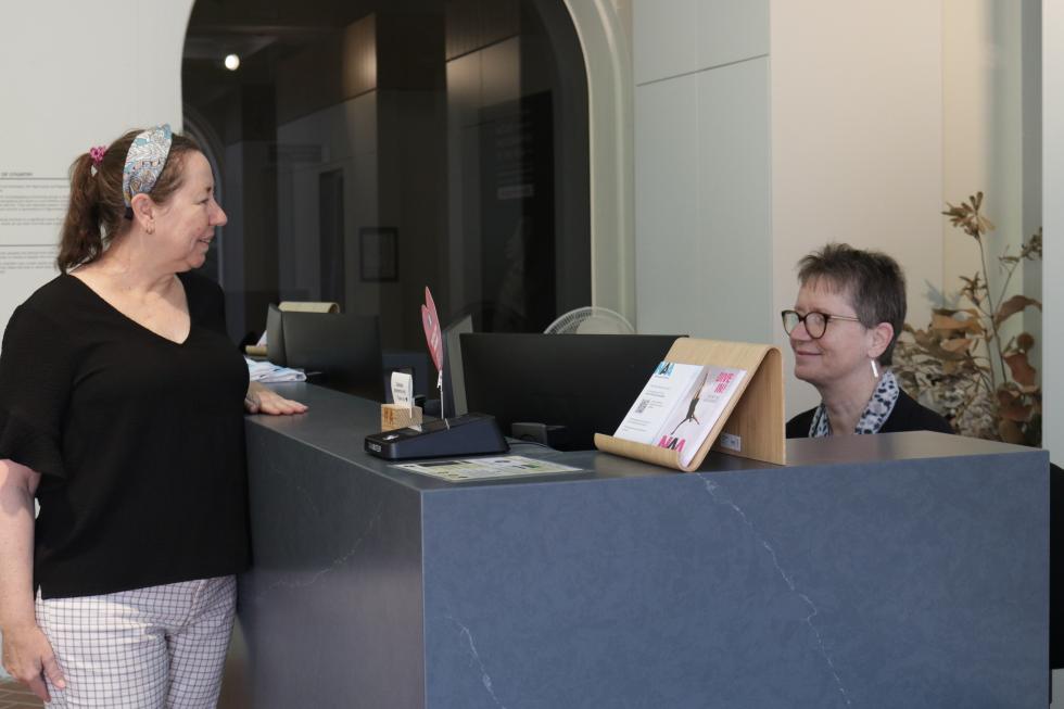 NAA staff member at reception desk