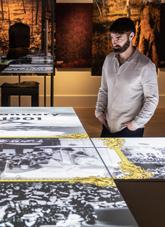 Man standing at a display in the Connections gallery. 