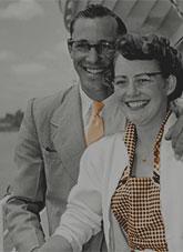 A man and woman standing beside a boat.