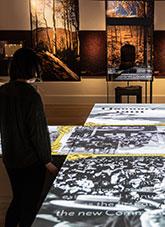A woman standing beside a projected image on a table