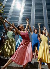People dressed in brightly coloured dance costume.