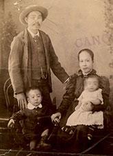 Formal studio photograph of a couple and their 2 children