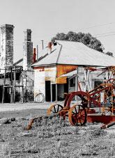 Abandoned building and horse drawn grader.