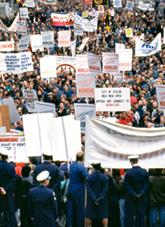 Protesters holding signs and banners. 
