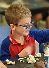 A child creating art at the National Archives of Australia