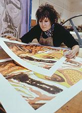 A print maker inspecting her work.