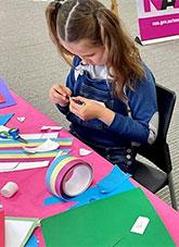 A child doing craft.