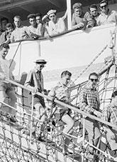 Men disembarking from a ship.