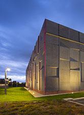 National Archives of Australia Preservation Facility under external lighting with evening sky.