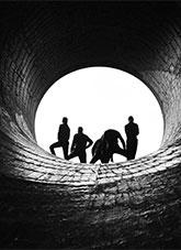 People standing at the end of a pipe provide an unusual silhouette at the the Murray II power station in the Australian Snowy Mountains Scheme near Khancoban.