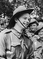 A young smiling World War 2 soldier.