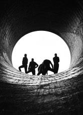 People standing at the end of a pipe provide an unusual silhouette at the the Murray II power station in the Australian Snowy Mountains Scheme near Khancoban.