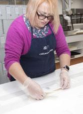 A paper conservator working in an archive laboratory.