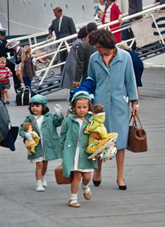 Family disembarking a migrant ship.