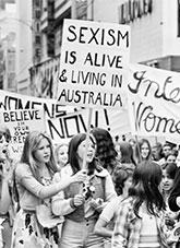 A protest march of people holding signs