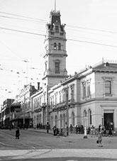 A large 2 story post office with ornate tower.